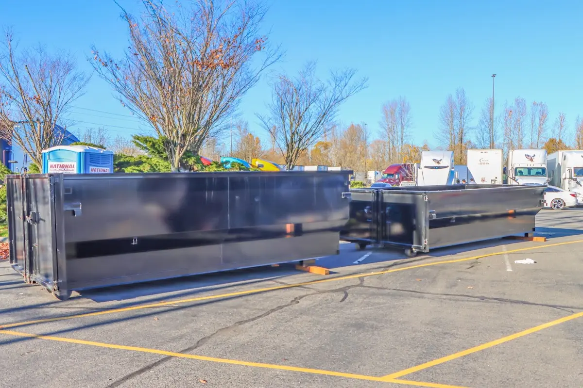 Professional dumpster rental service with roll-off container on residential driveway in Knik-Fairview